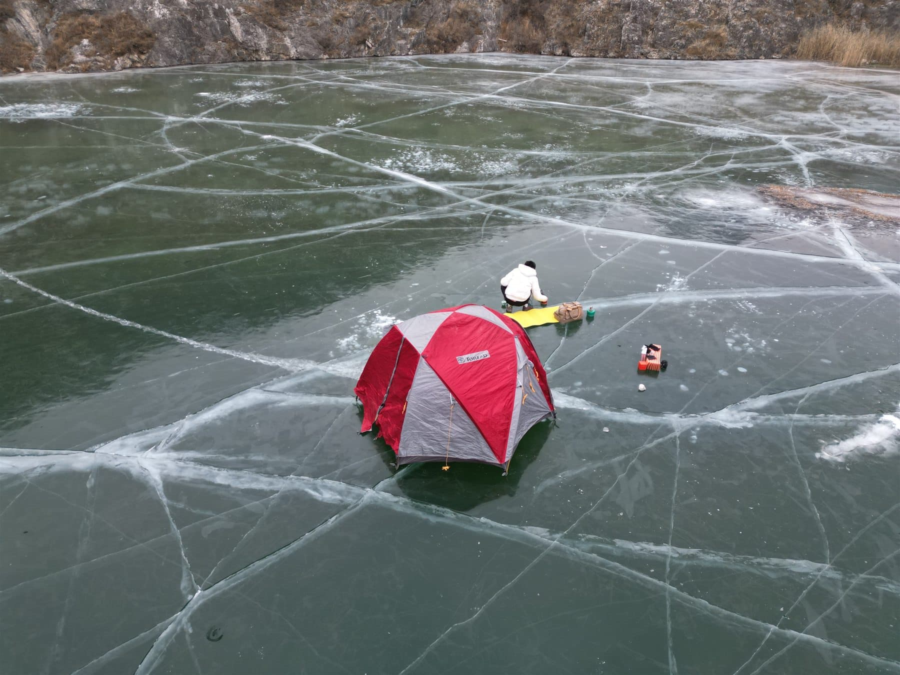 Red tent on a frozen lake